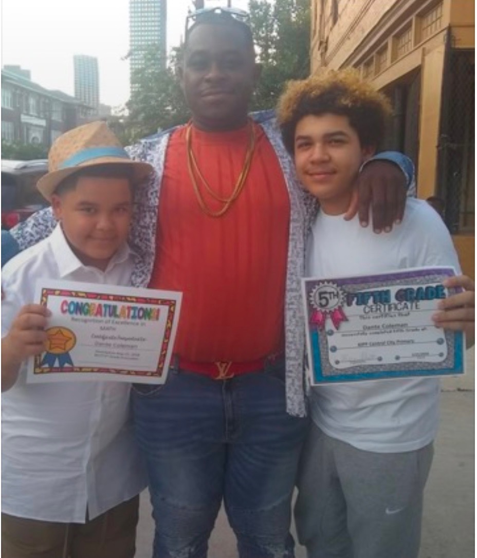 Willie Coleman with his two sons celebrating their school achievements